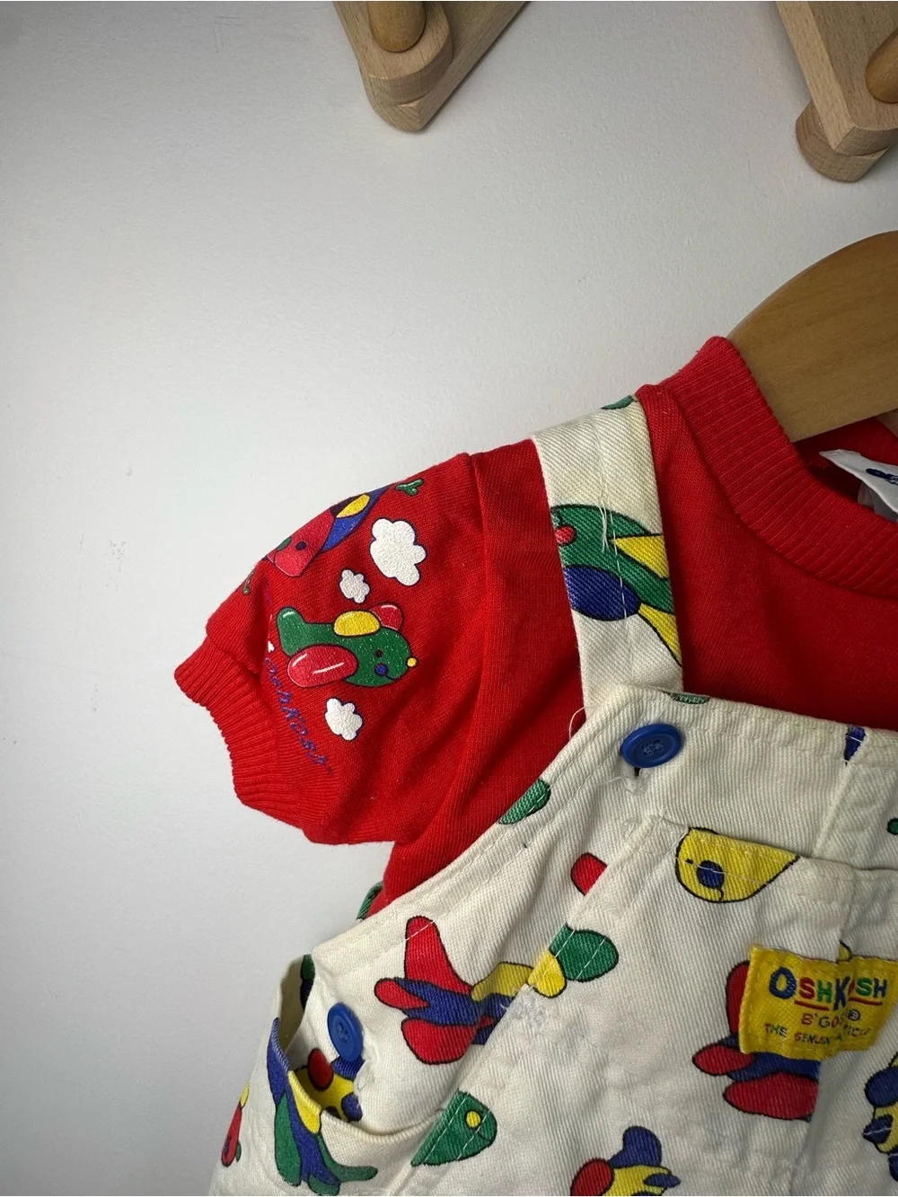OshKosh B'gosh White Overalls with Colorful Airplane Print and Red Accents